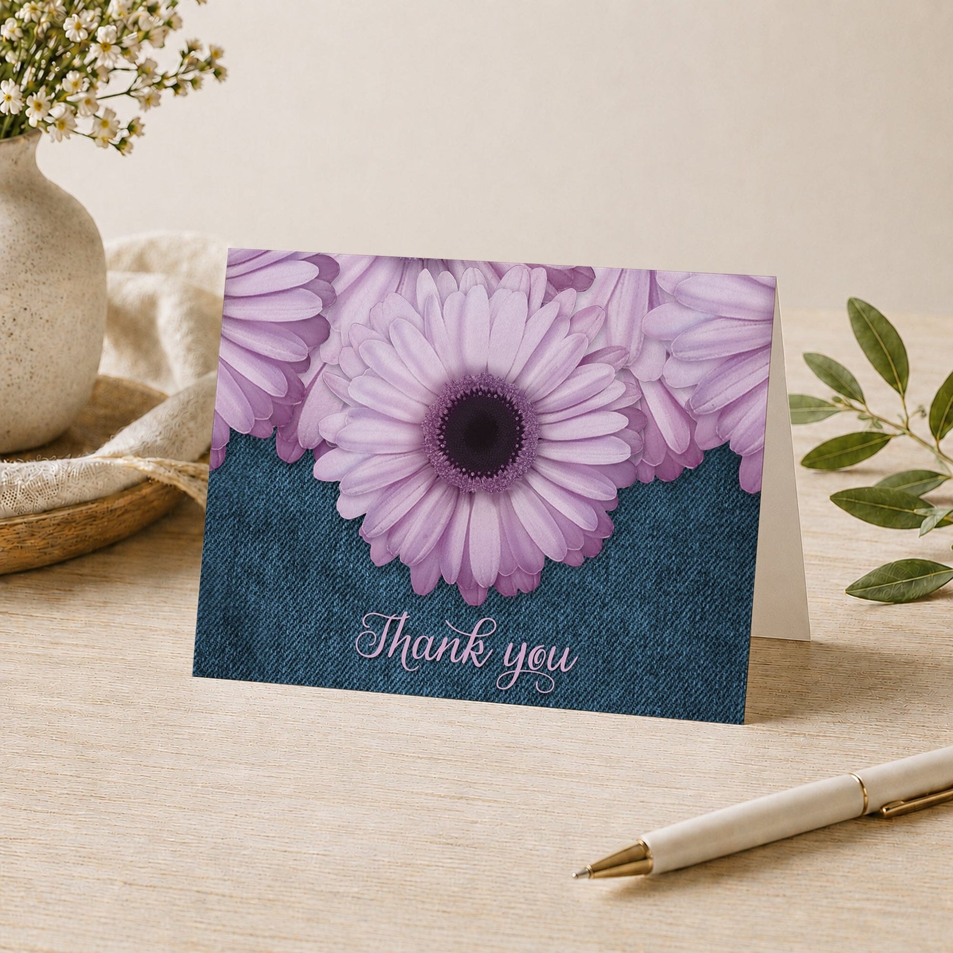 Rustic Purple Daisy Denim Thank You Card shown on a desk with a vase, plants, and a pen.