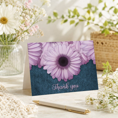 Rustic Purple Daisy Denim Thank You Card shown on a tabletop with a vase, spring and summer flowers, and a pen.
