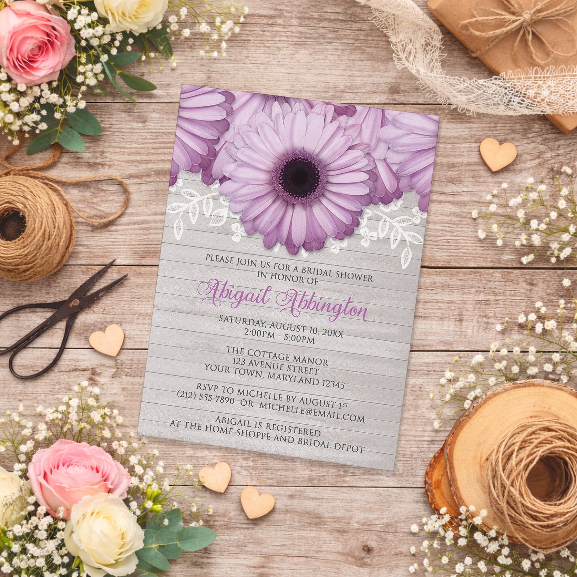 Rustic Purple Daisy Gray Wood Bridal Shower Invitation on a wooden surface with spring and summer flowers and twine.