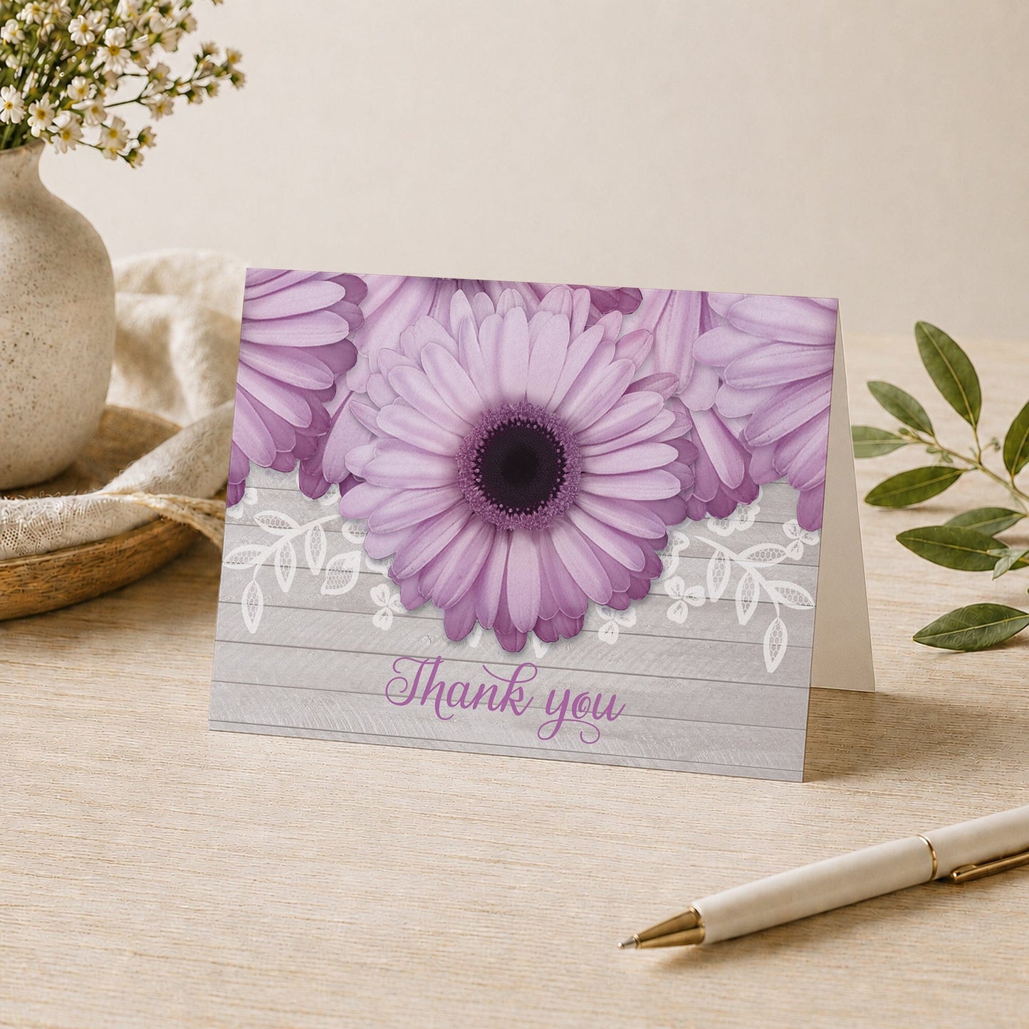 Rustic Purple Daisy Gray Wood Thank You Card shown on a desk with a vase, plants, and a pen.