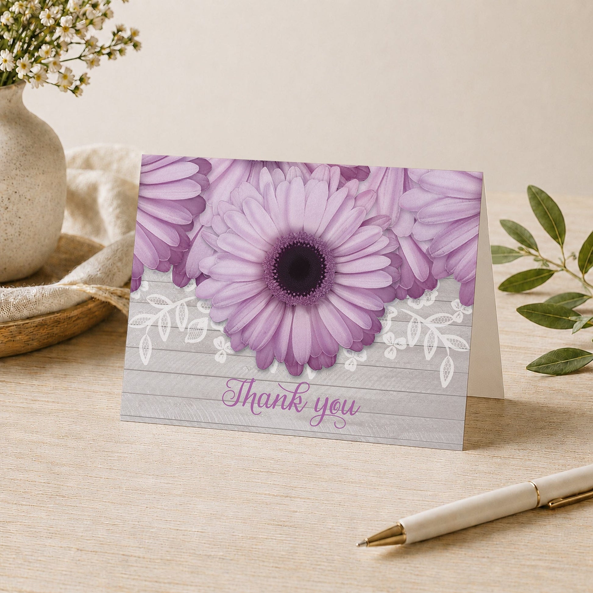 Rustic Purple Daisy Gray Wood Thank You Card shown on a desk with a vase, plants, and a pen.
