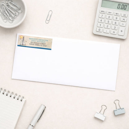 Rustic Sailboat Nautical Address Label shown on a white envelope with everyday office supplies