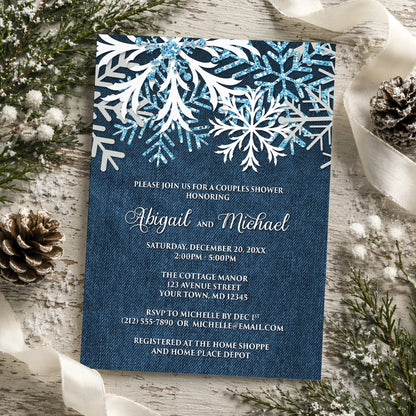 Rustic Snowflake Denim Winter Couples Shower Invitation on a rustic wood surface with winter greenery, ribbons, and pine cones.
