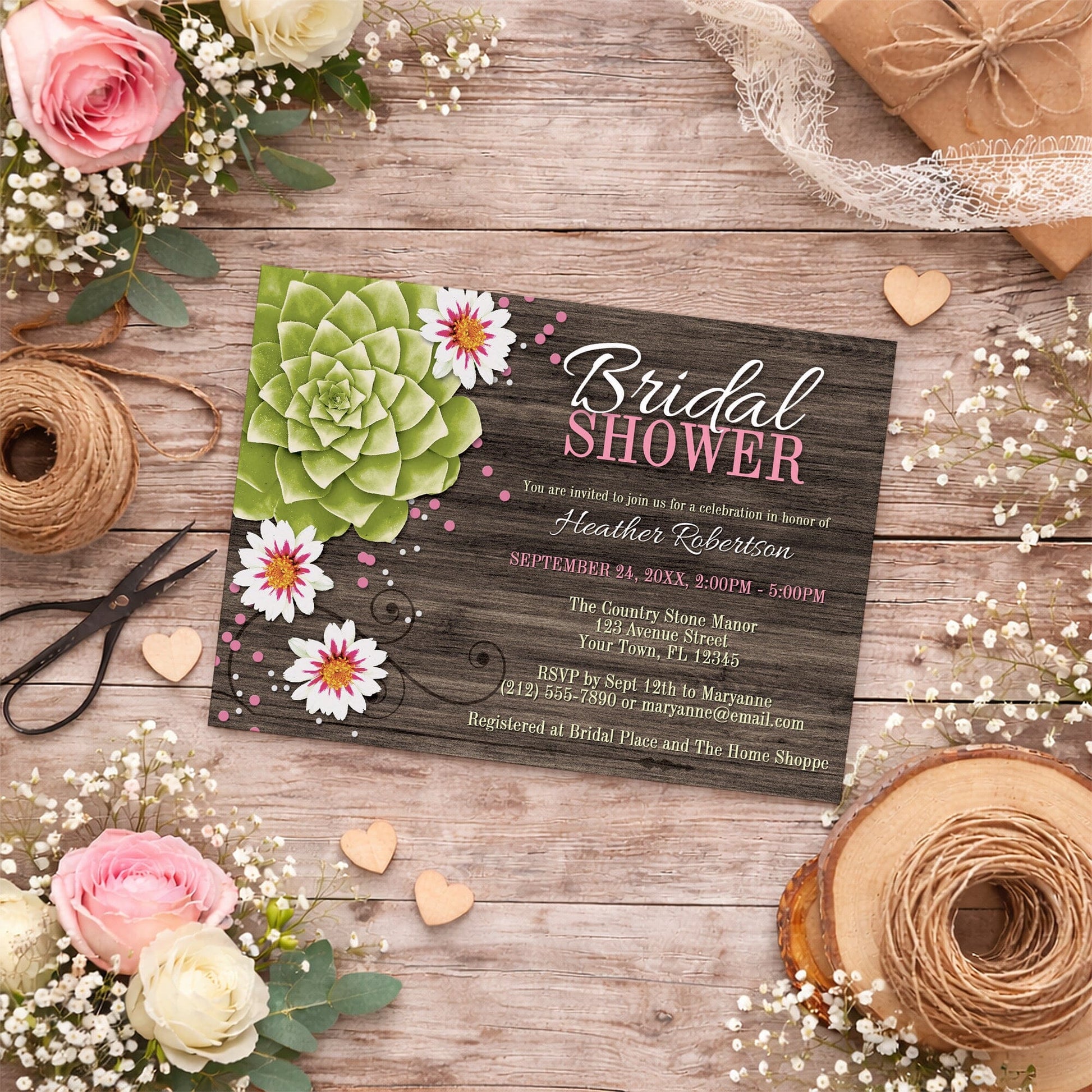 Rustic Succulent Floral Bridal Shower Invitation on a wooden surface with flowers, twine, and wooden hearts.