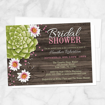 Rustic bridal shower invitation with a green succulent, white flowers, and pink and white confetti dots over a brown wood background, displayed with a white envelope on a marble surface