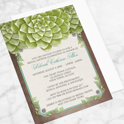 Rustic Succulent Garden Bridal Shower Invitation shown at an angle on a marble surface with a white envelope.