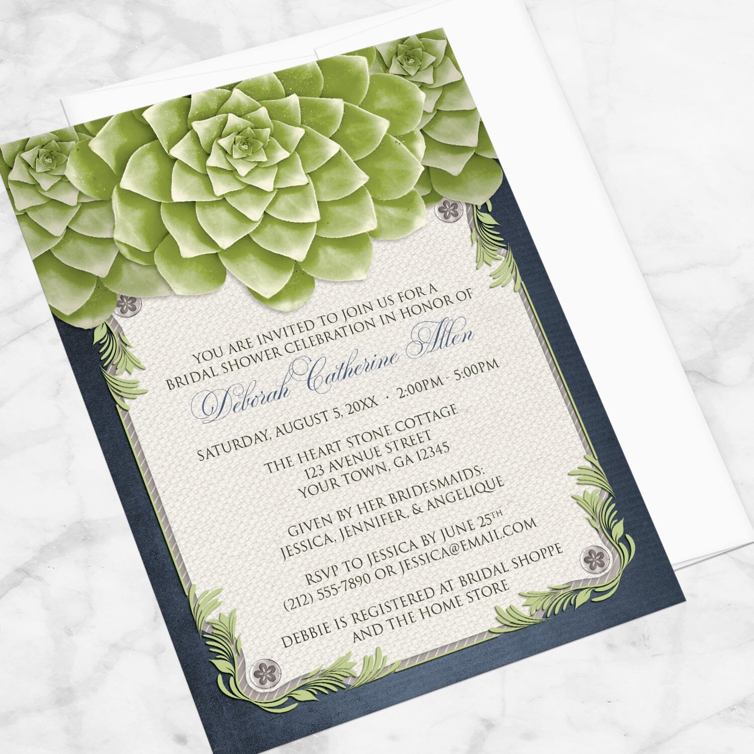 Bridal shower invitation with green succulents with navy blue and beige, displayed at an angle with a white envelope on a marble surface