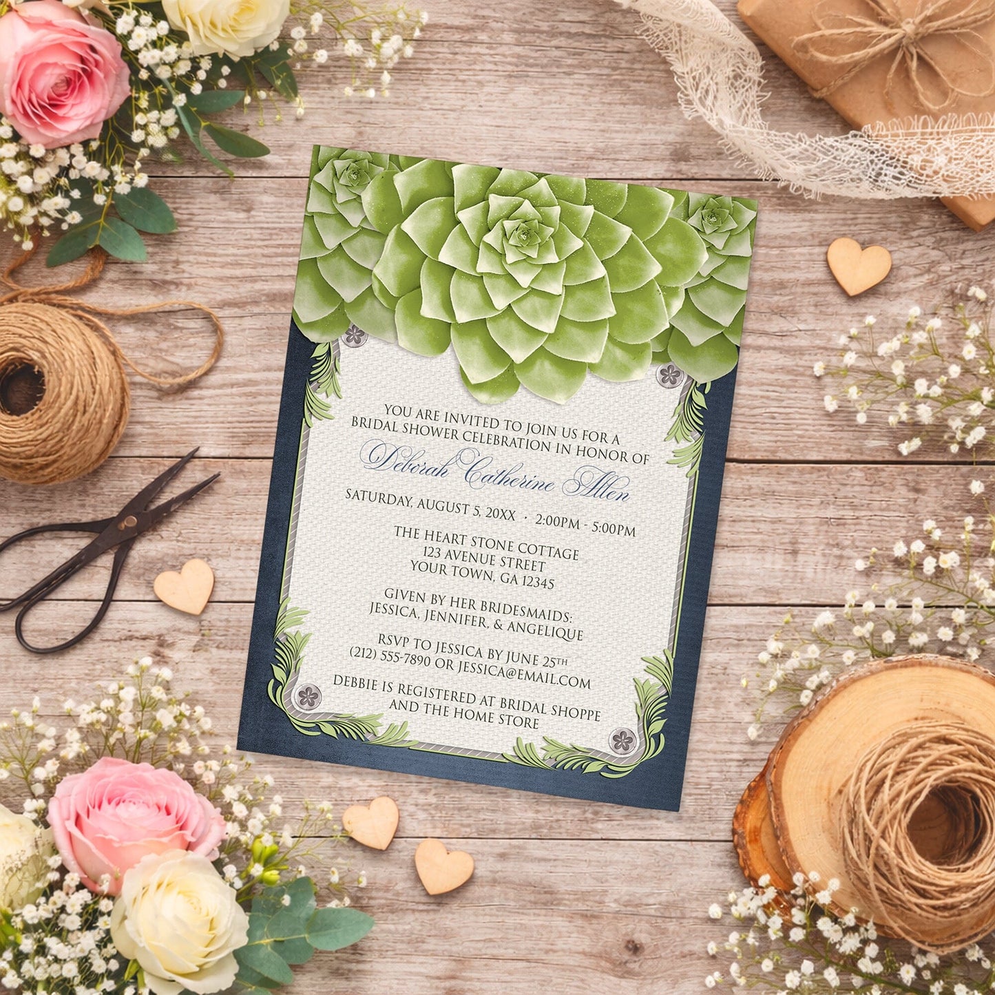 Rustic Succulent Garden Navy Bridal Shower Invitation on a wooden surface with spring and summer flowers, wooden hearts, and twine.