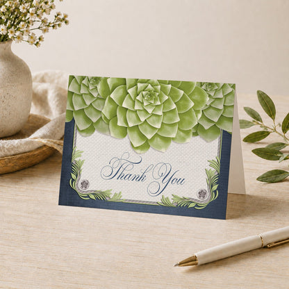 Rustic Succulent Garden Navy Thank You Card shown on a desk with a vase, plants, and a pen.