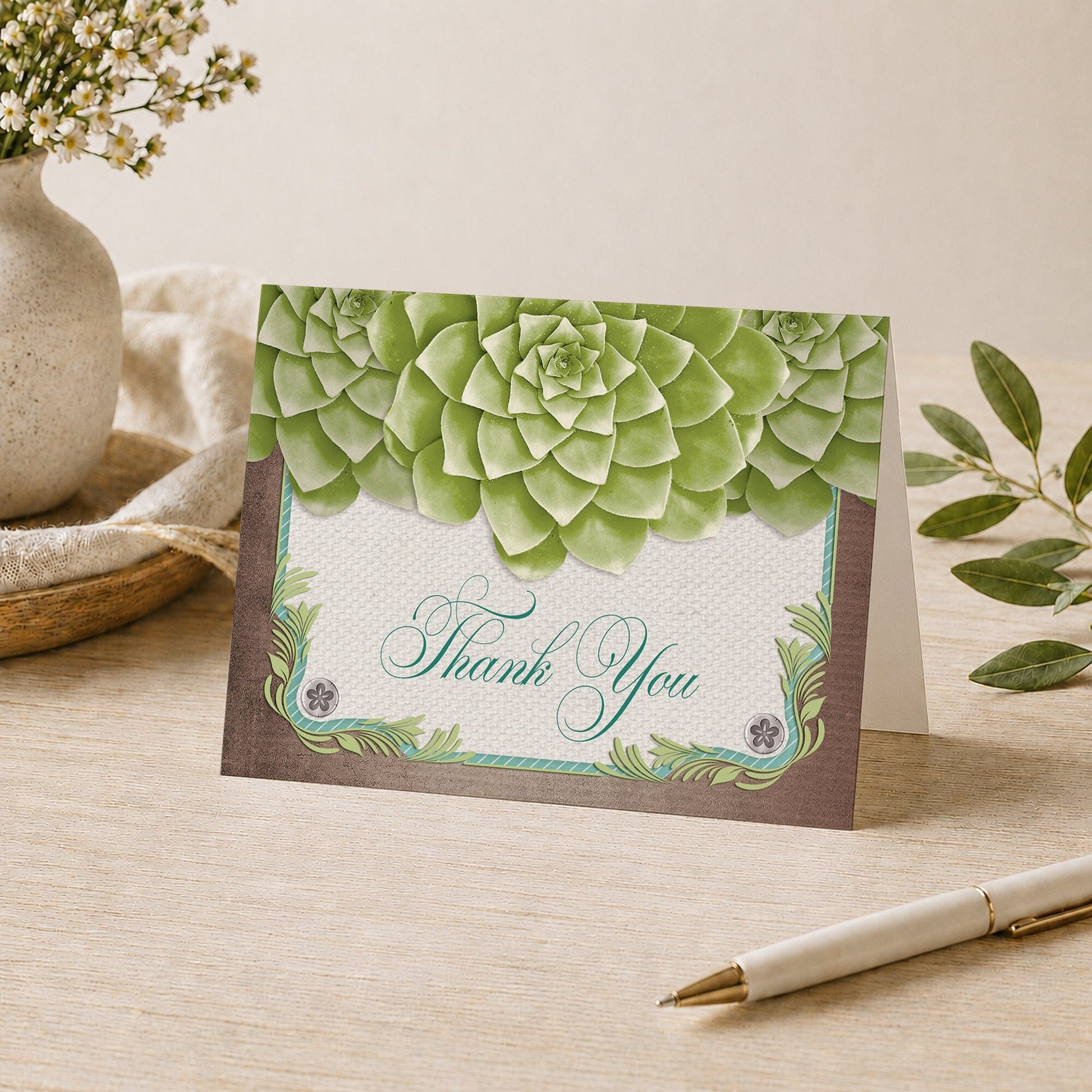 Rustic Succulent Garden Thank You Card shown on a desk with a vase, plants, and a pen.