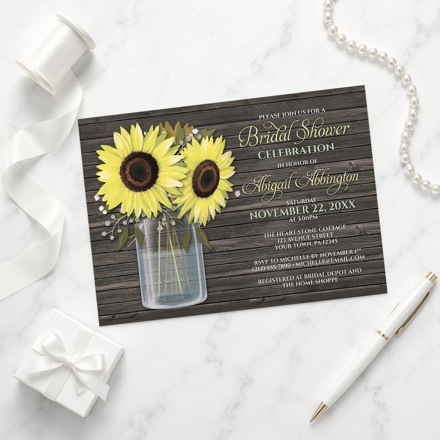 Rustic Sunflower Wood Mason Jar Bridal Shower Invitation on a marble surface with wedding shower items.