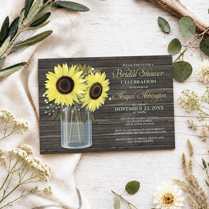 Rustic Sunflower Wood Mason Jar Bridal Shower Invitation on a light wooden surface with spring and summer plants.