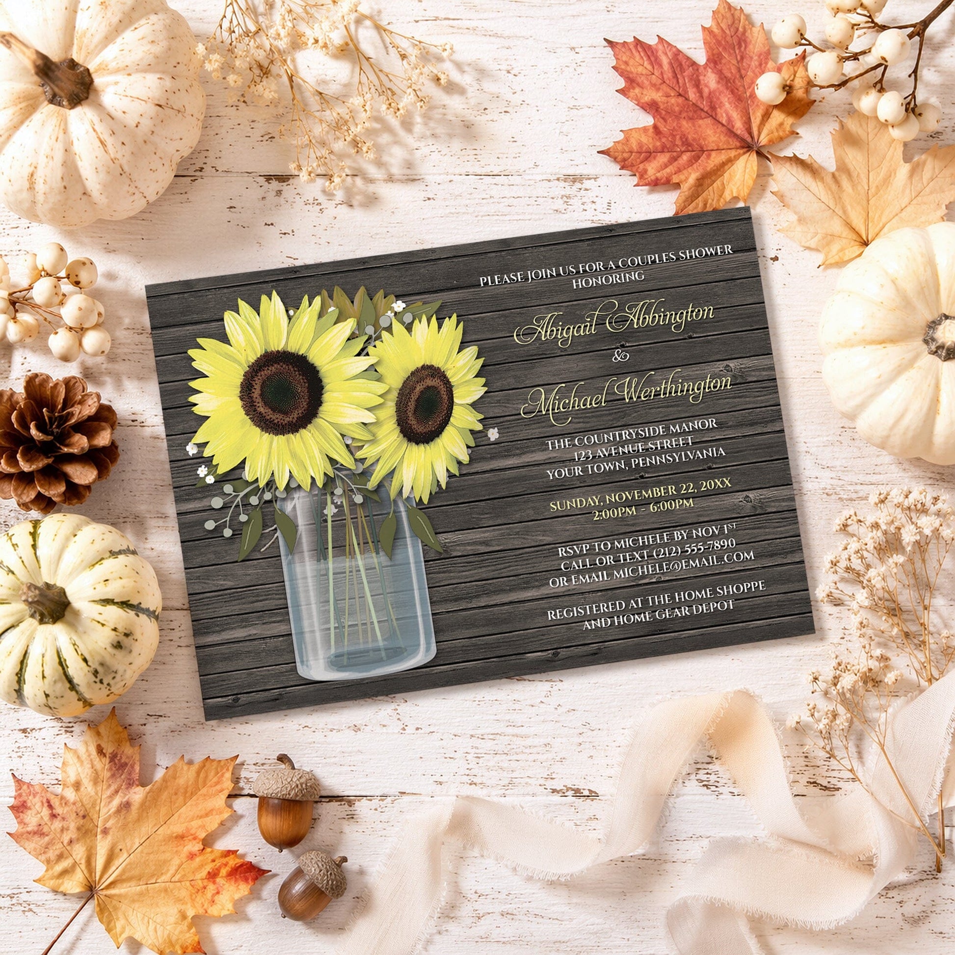 Rustic Sunflower Wood Mason Jar Couples Shower Invitation shown on a light wooden surface with fall leaves and autumn decor.