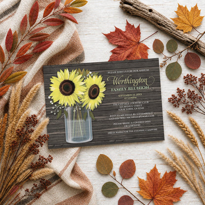 Rustic Sunflower Wood Mason Jar Family Reunion Invitation on a wooden surface with fall leaves and autumn decor.