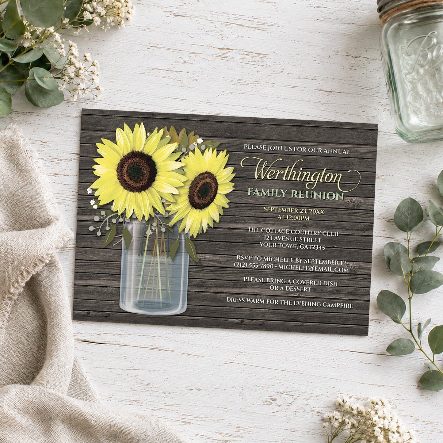 Rustic Sunflower Wood Mason Jar Family Reunion Invitation on a wooden surface with a mason jar and plants.