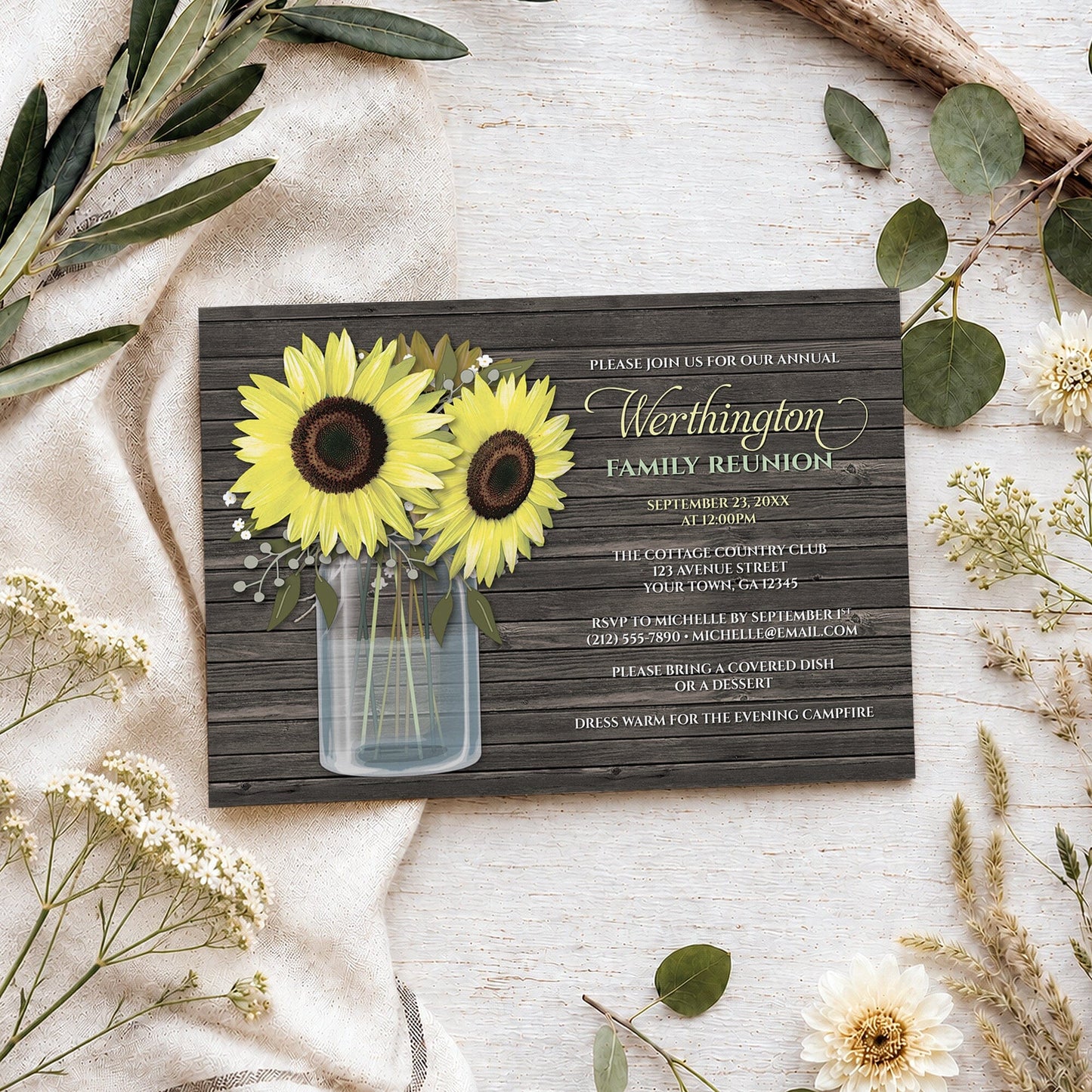 Rustic Sunflower Wood Mason Jar Family Reunion Invitation on a wooden surface with spring and summer plants.