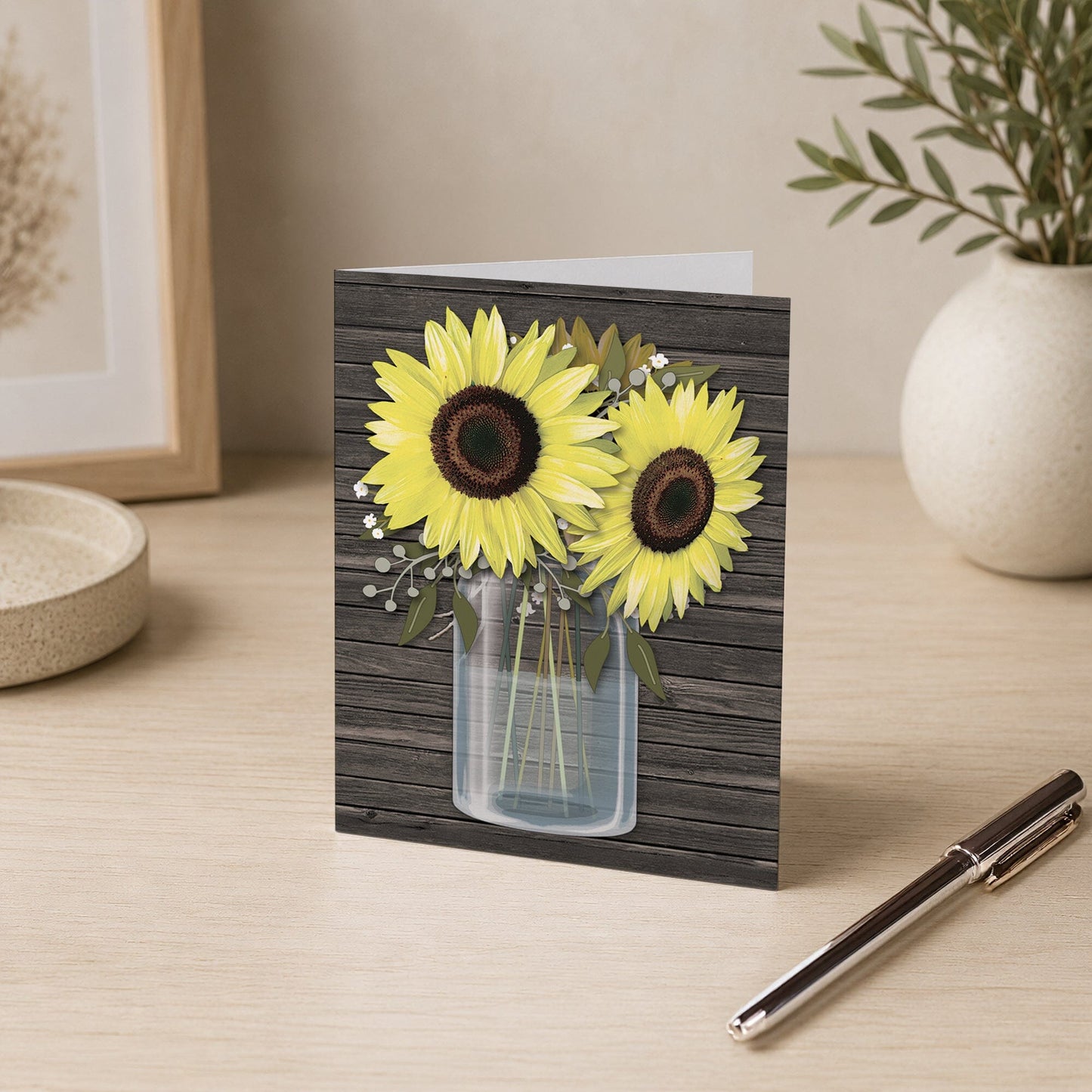 Rustic Sunflower Wood Mason Jar Note Card shown on a desk with a vase and a pen.