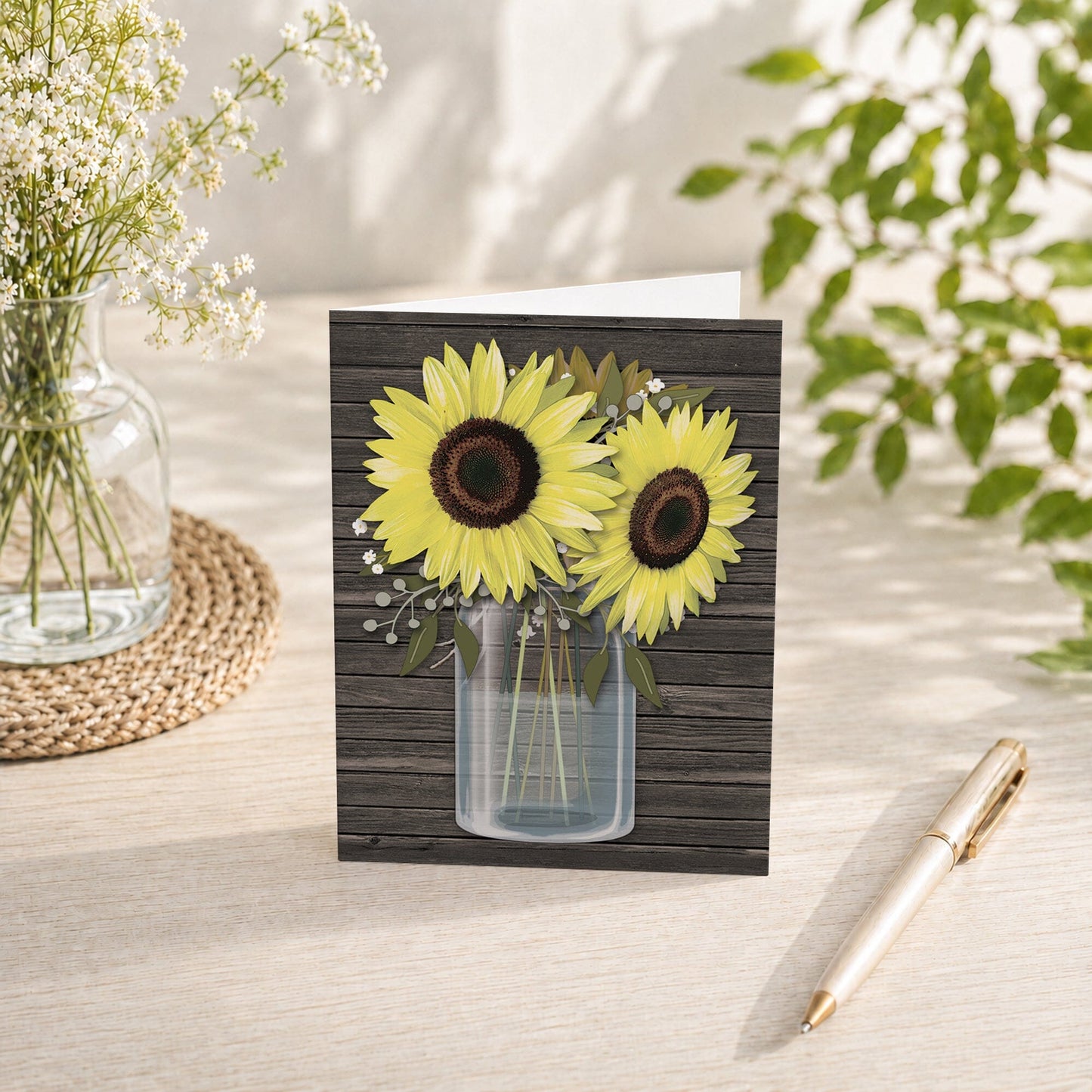 Rustic Sunflower Wood Mason Jar Note Card shown on a tabletop with a vase, summer flowers, and a pen.