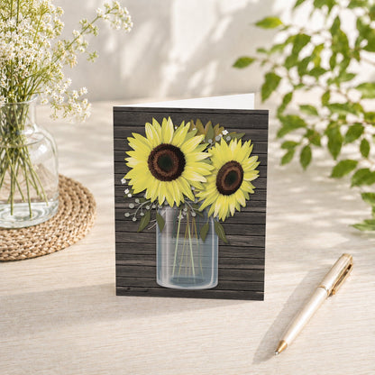 Rustic Sunflower Wood Mason Jar Note Card shown on a tabletop with a vase, summer flowers, and a pen.