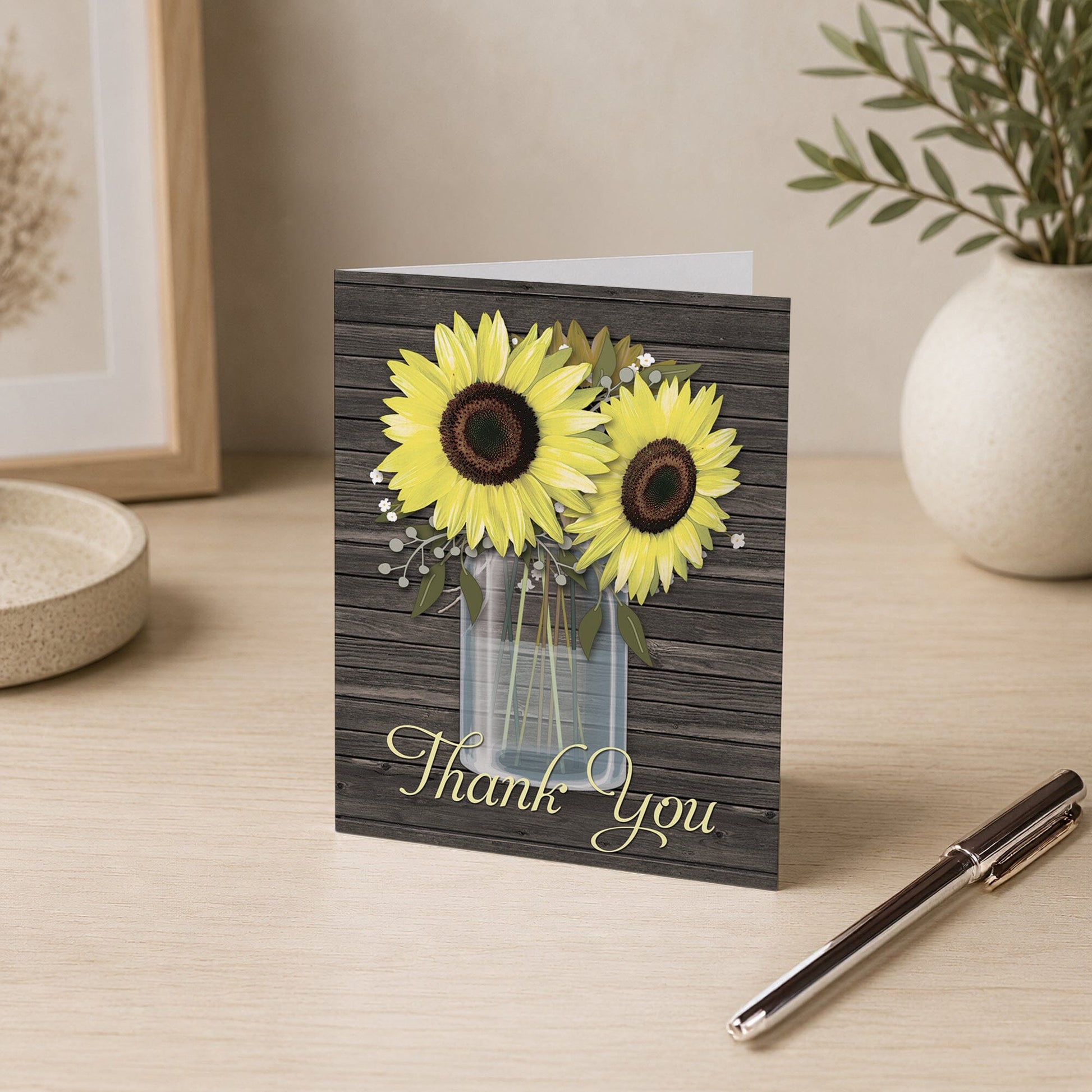 Rustic Sunflower Wood Mason Jar Thank You Card shown on a desk with a vase and a pen.