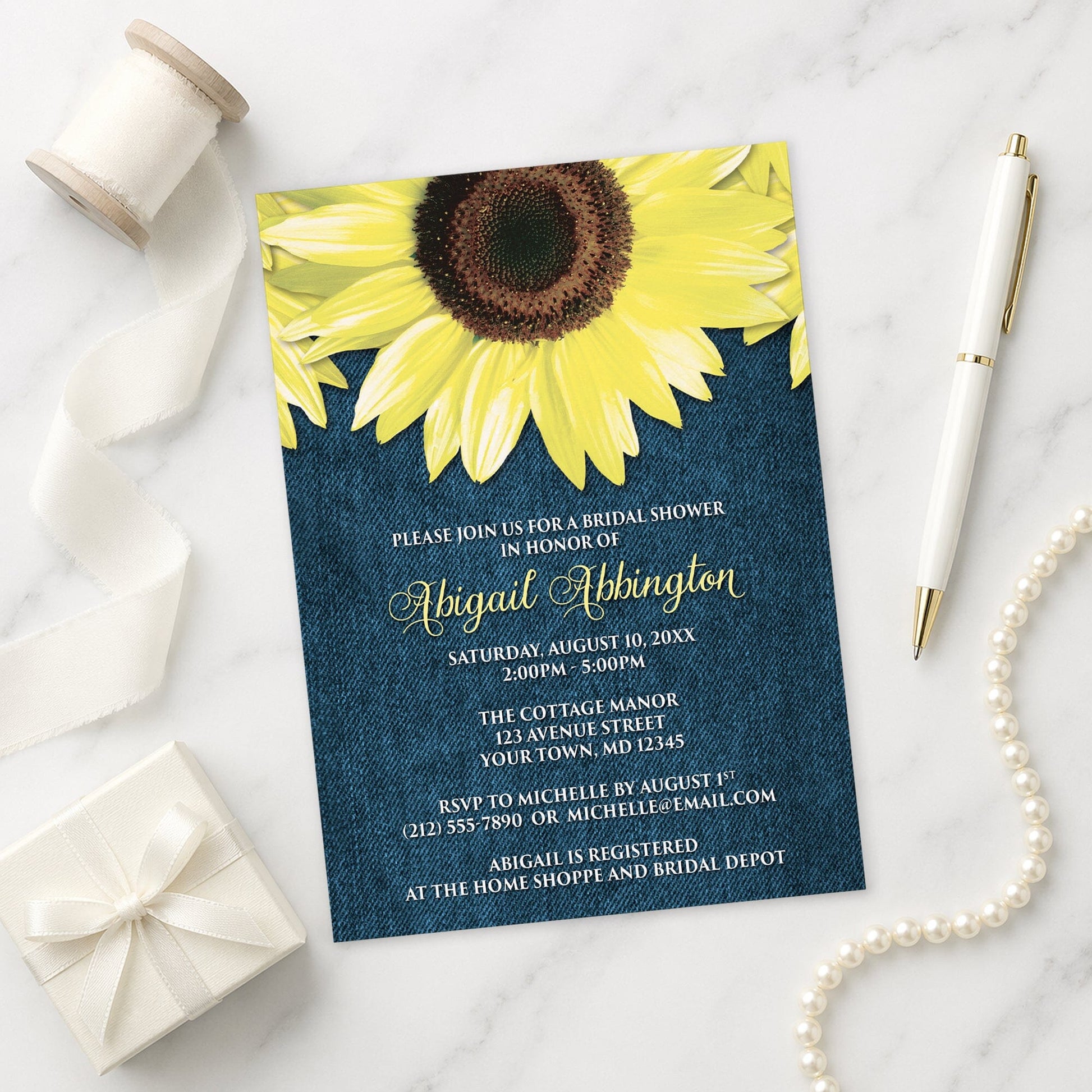 Rustic Sunflower and Denim Bridal Shower Invitation on a marble surface with a white gift box, ribbon, pen, and pearls.