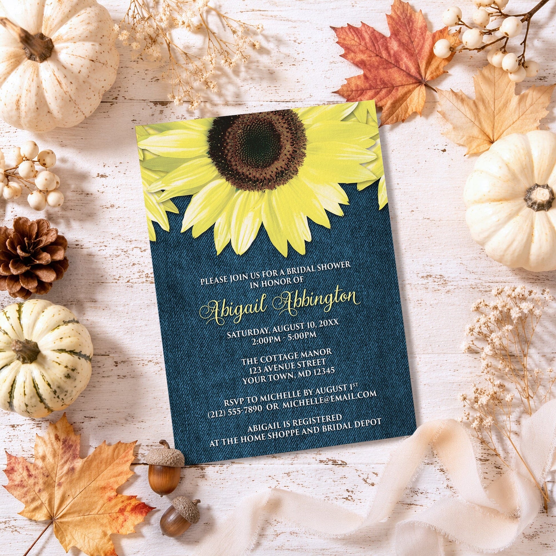 Rustic Sunflower and Denim Bridal Shower Invitation on a wooden surface with autumn decorations