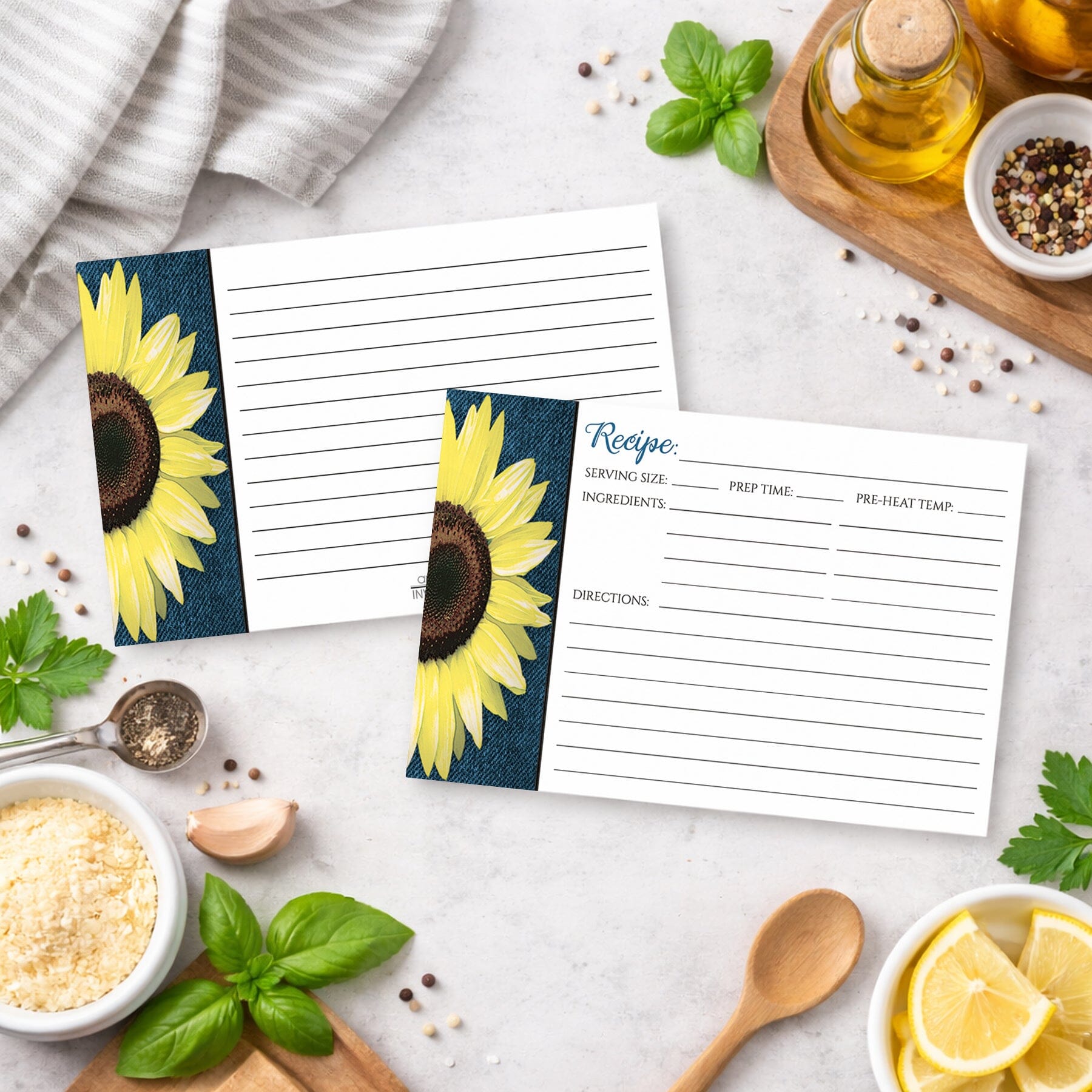 Two Rustic Sunflower and Denim Recipe Cards on a kitchen counter with ingredients.