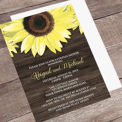 Rustic Sunflower and Wood Couples Shower Invitation shown at an angle on a brown wood surface with a white envelope.