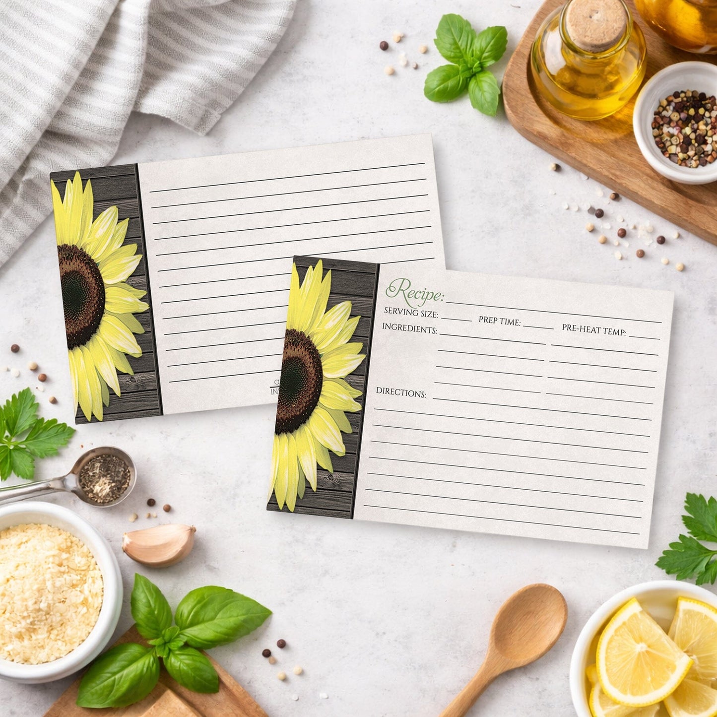 Two Rustic Sunflower and Wood Recipe Cards on a kitchen counter with ingredients and utensils.