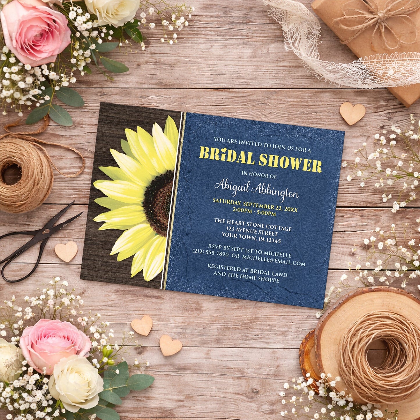 Rustic Sunflower with Blue Bridal Shower Invitation shown on a country wooden surface with summer flowers, small wood hearts, and twine.
