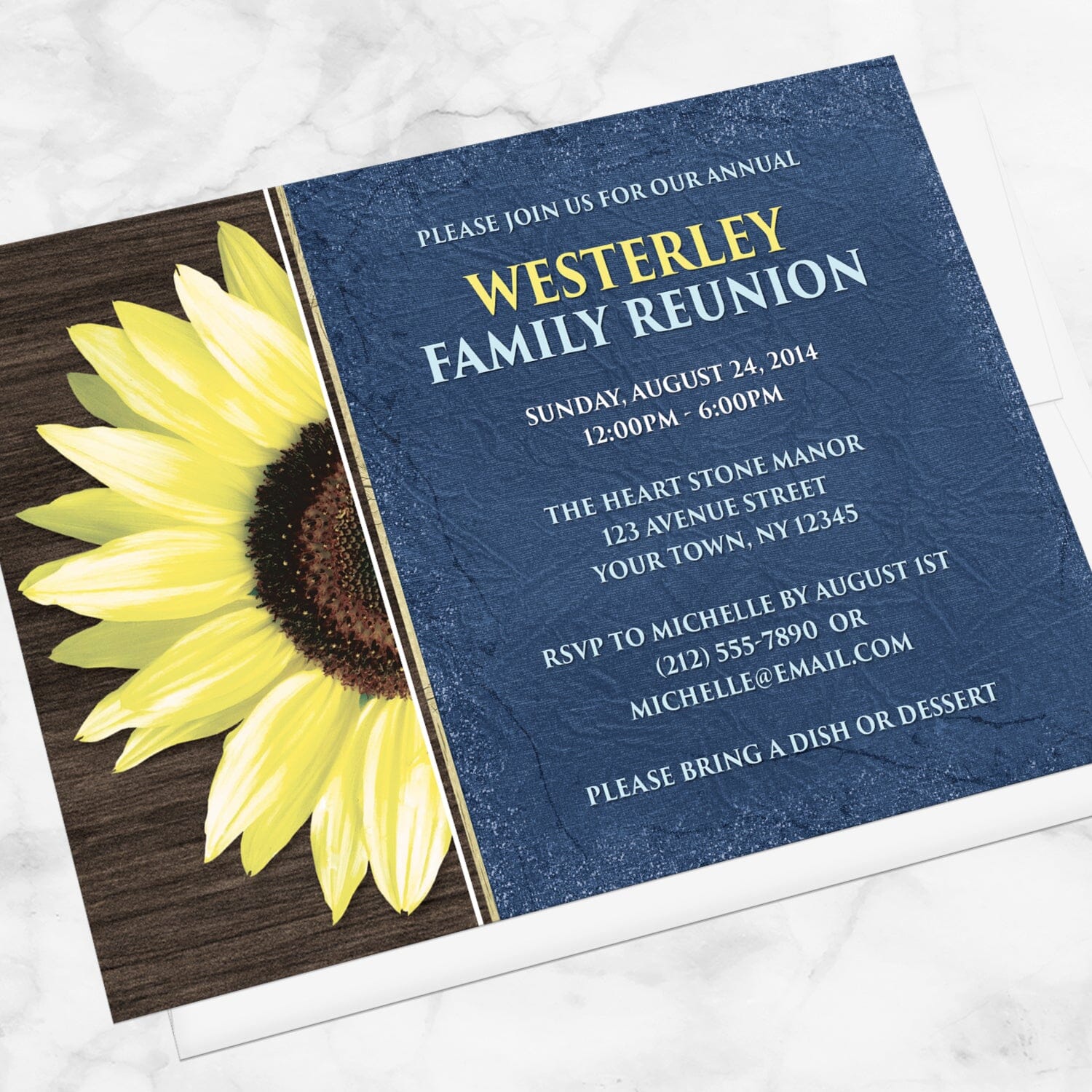 Rustic Sunflower with Blue Family Reunion Invitation shown at an angle on a marble surface with a white envelope.