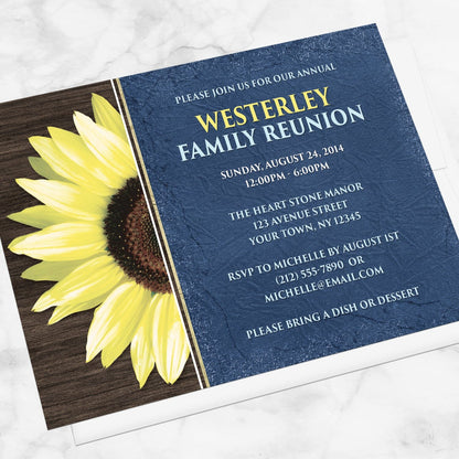 Rustic Sunflower with Blue Family Reunion Invitation shown at an angle on a marble surface with a white envelope.