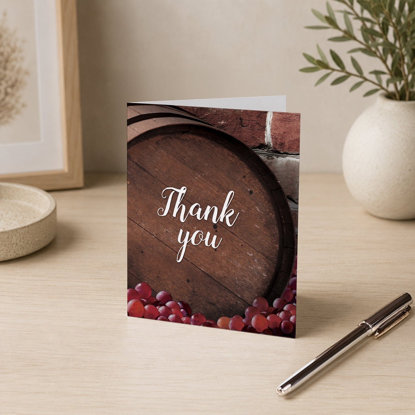 Rustic Wine Barrel Vineyard Thank You Card shown on a desk with a vase and a pen.