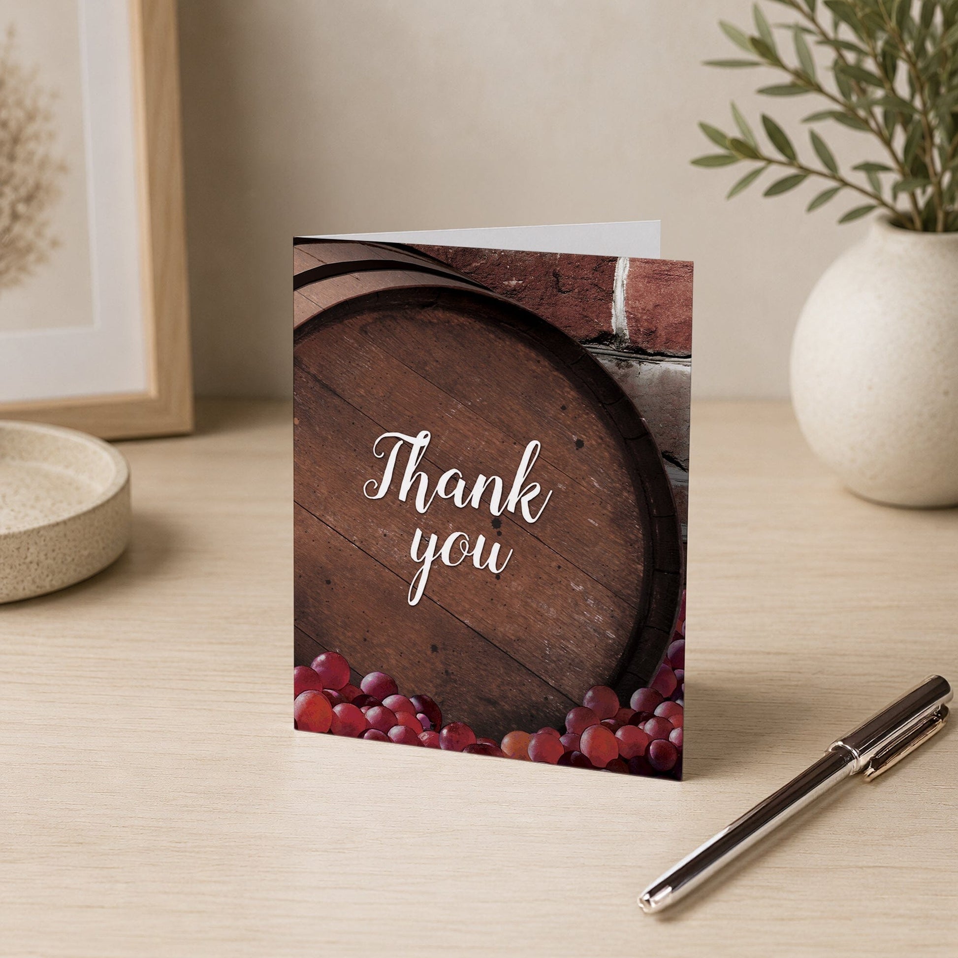 Rustic Wine Barrel Vineyard Thank You Card shown on a desk with a vase and a pen.