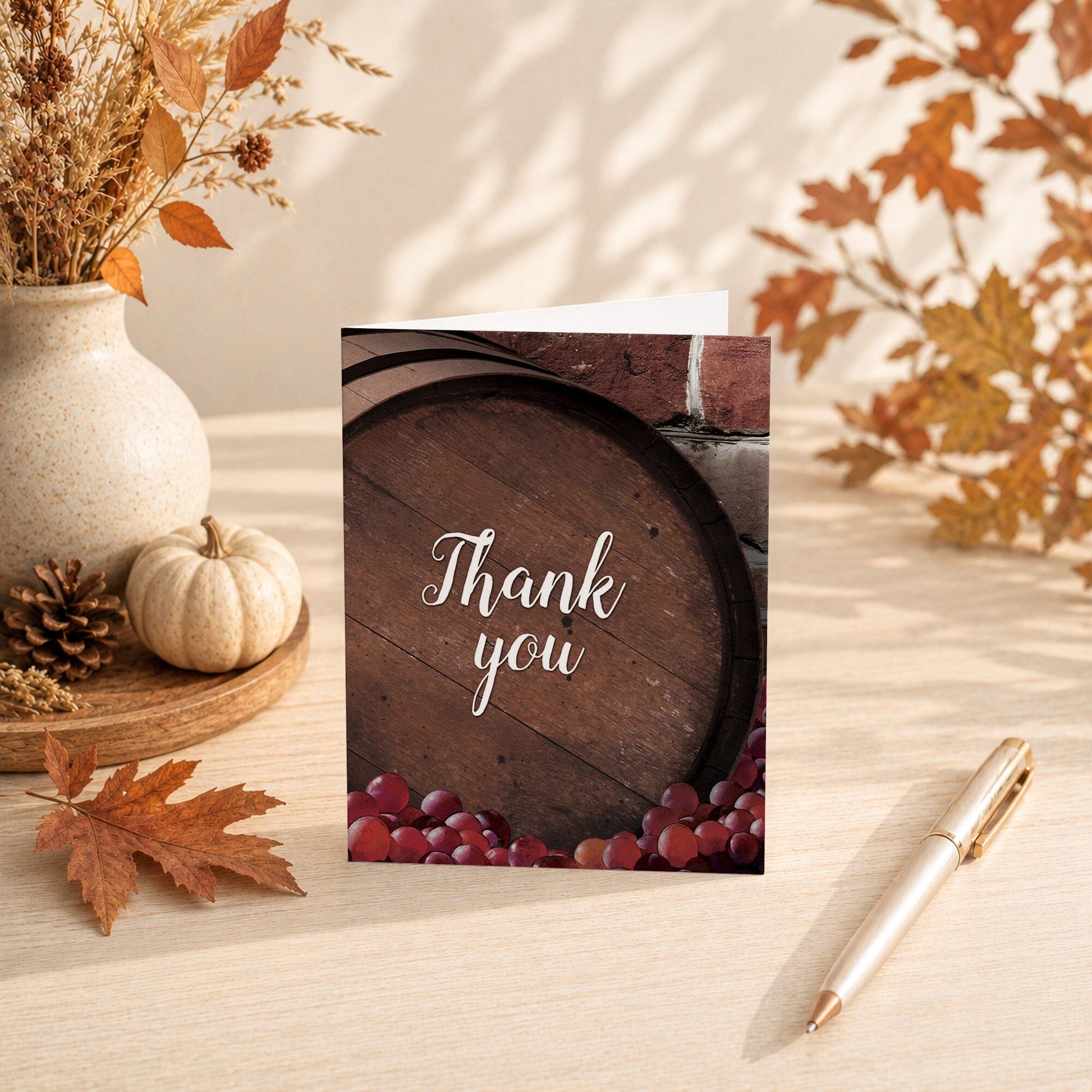 Rustic Wine Barrel Vineyard Thank You Card shown on a tabletop with fall leaves and autumn decor.