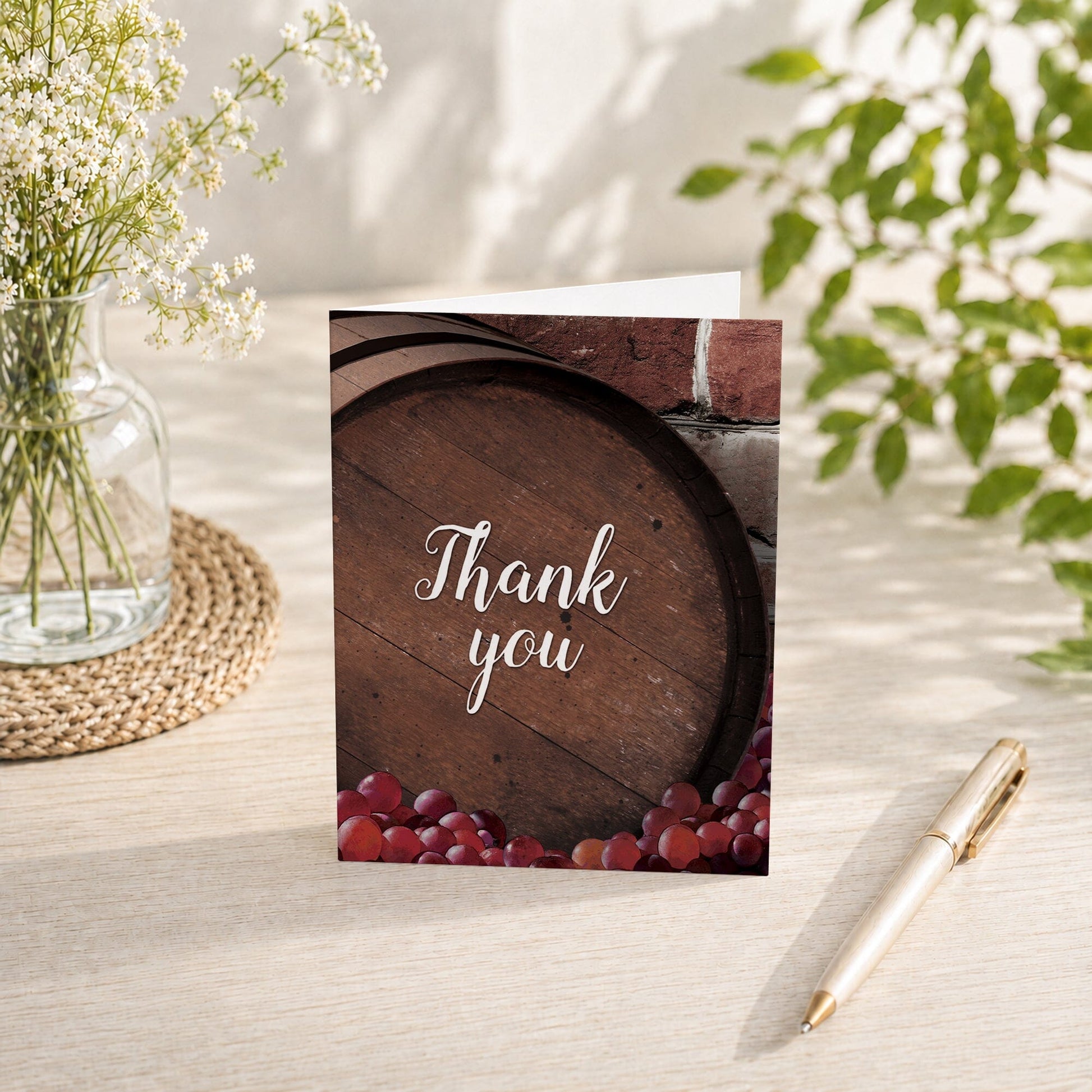 Rustic Wine Barrel Vineyard Thank You Card shown on a tabletop with spring and summer flowers and a pen.