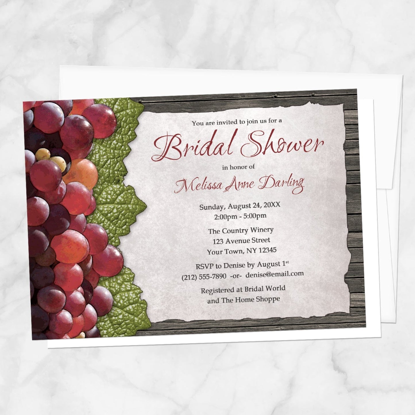 Rustic Winery Grapes and Wood Bridal Shower Invitation shown on a marble surface with a white envelope.