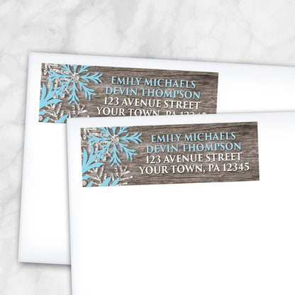 2 Rustic Winter Wood Blue Snowflake Address Labels shown on white envelopes on a marble surface