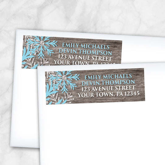 2 Rustic Winter Wood Blue Snowflake Address Labels shown on white envelopes on a marble surface
