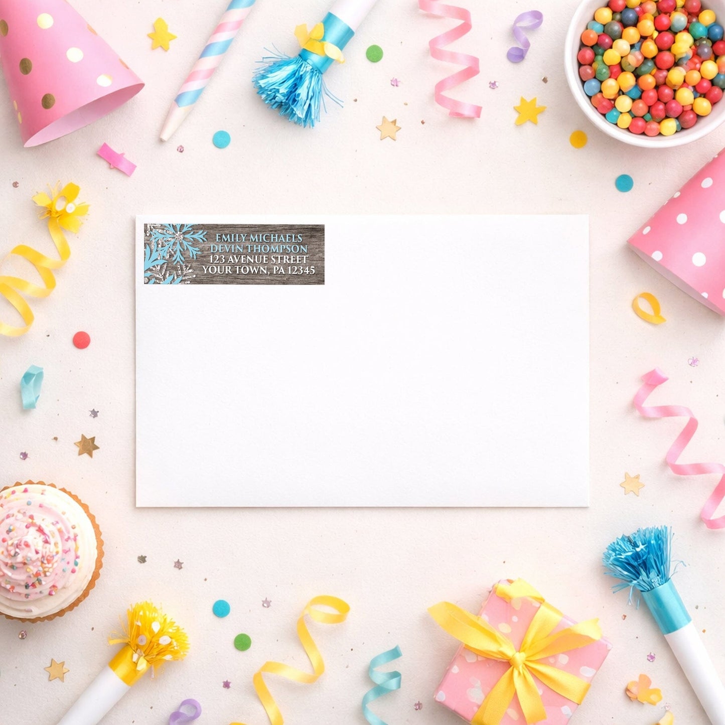 Rustic Winter Wood Blue Snowflake Address Label shown on a white envelope with party supplies