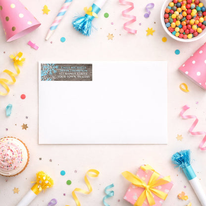 Rustic Winter Wood Blue Snowflake Address Label shown on a white envelope with party supplies