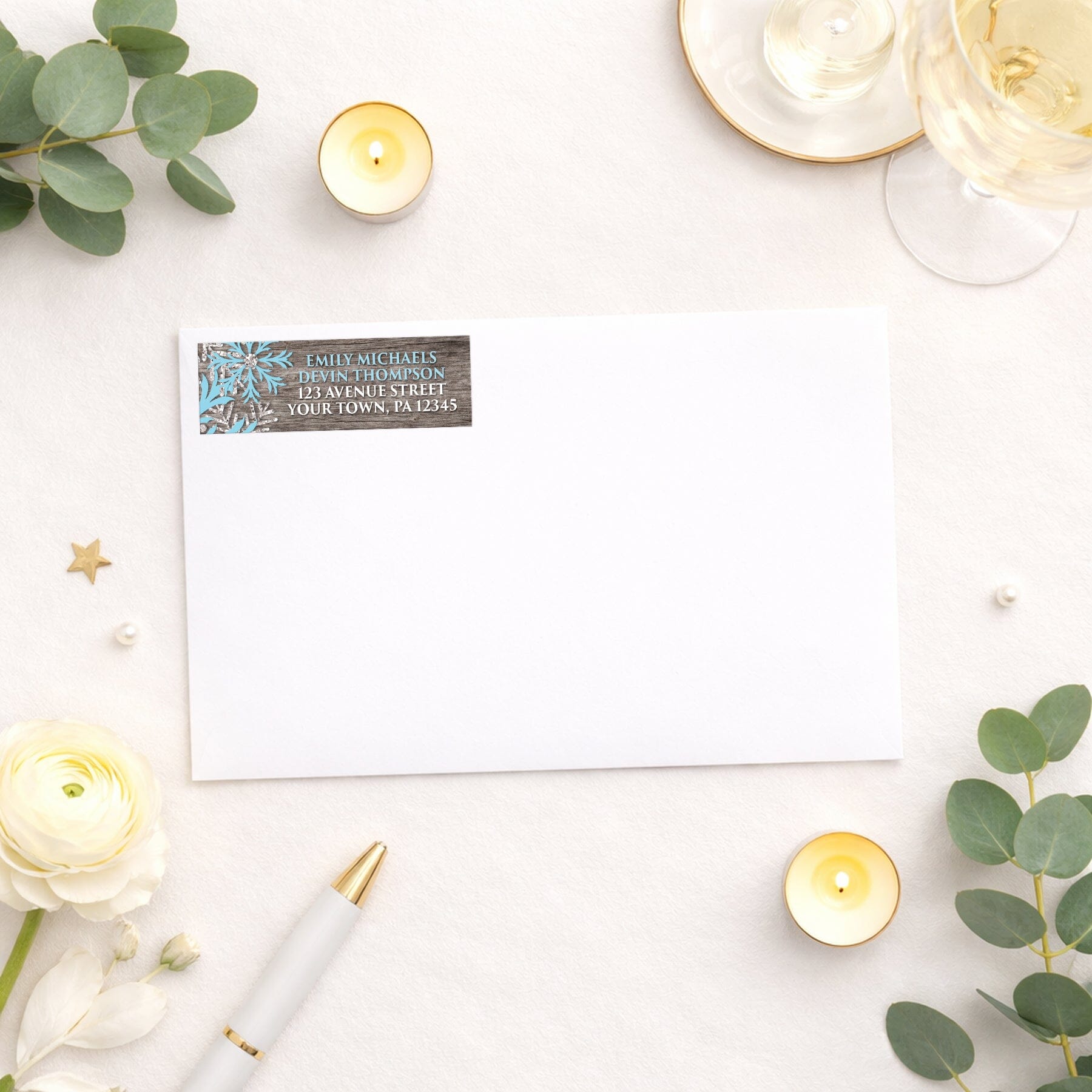 Rustic Winter Wood Blue Snowflake Address Label shown on a white envelope with wedding and shower supplies