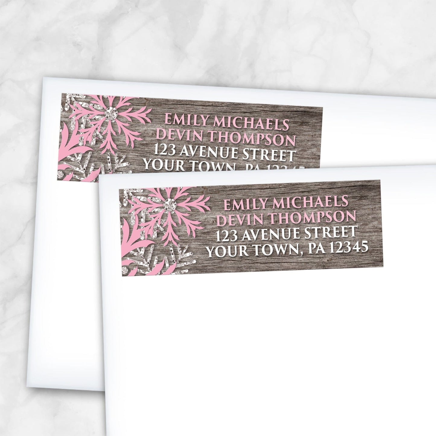 2 Rustic Winter Wood Pink Snowflake Address Labels shown on white envelopes on a marble surface