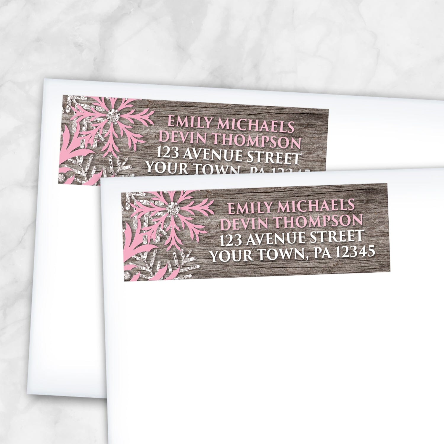 2 Rustic Winter Wood Pink Snowflake Address Labels shown on white envelopes on a marble surface