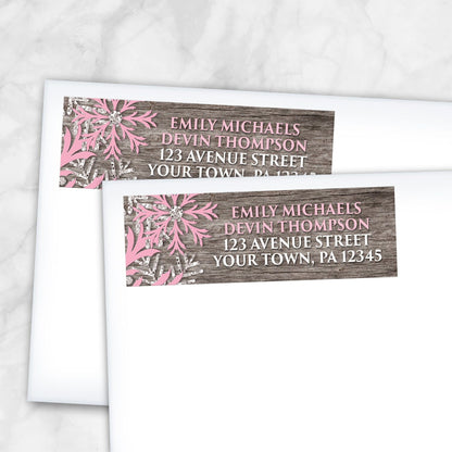 2 Rustic Winter Wood Pink Snowflake Address Labels shown on white envelopes on a marble surface