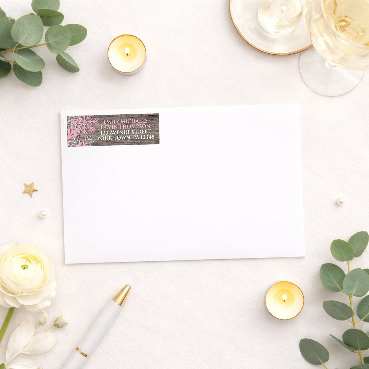 Rustic Winter Wood Pink Snowflake Address Label shown on a white envelope with wedding and shower supplies