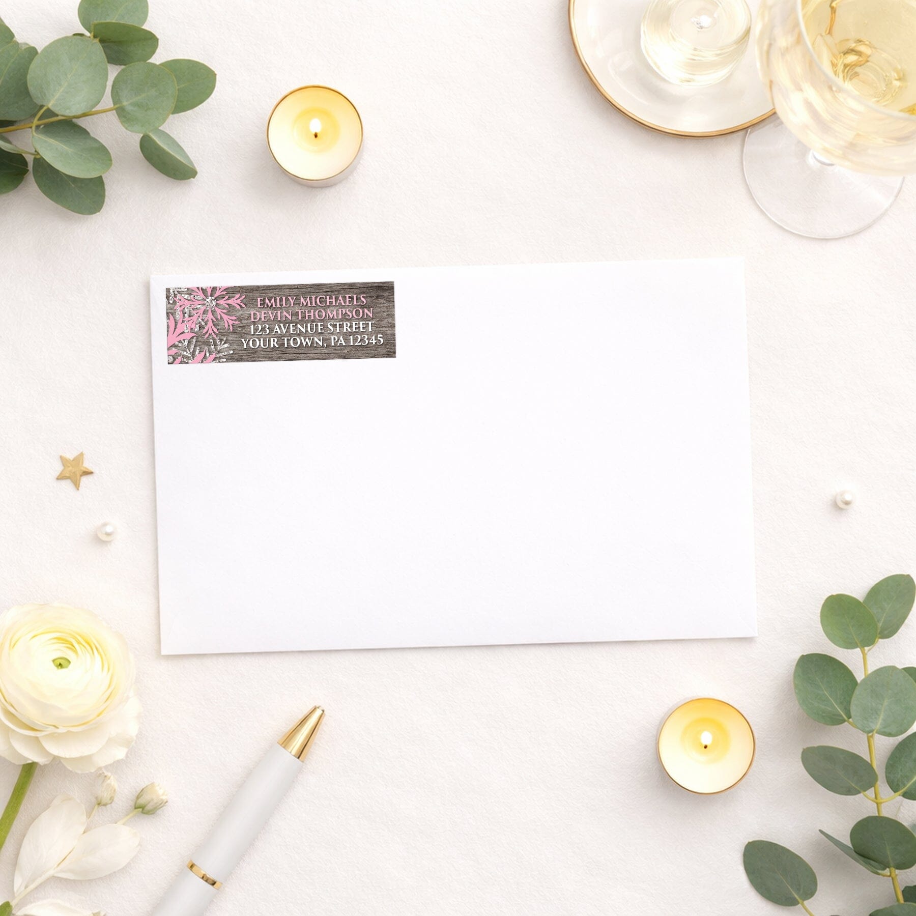 Rustic Winter Wood Pink Snowflake Address Label shown on a white envelope with wedding and shower supplies