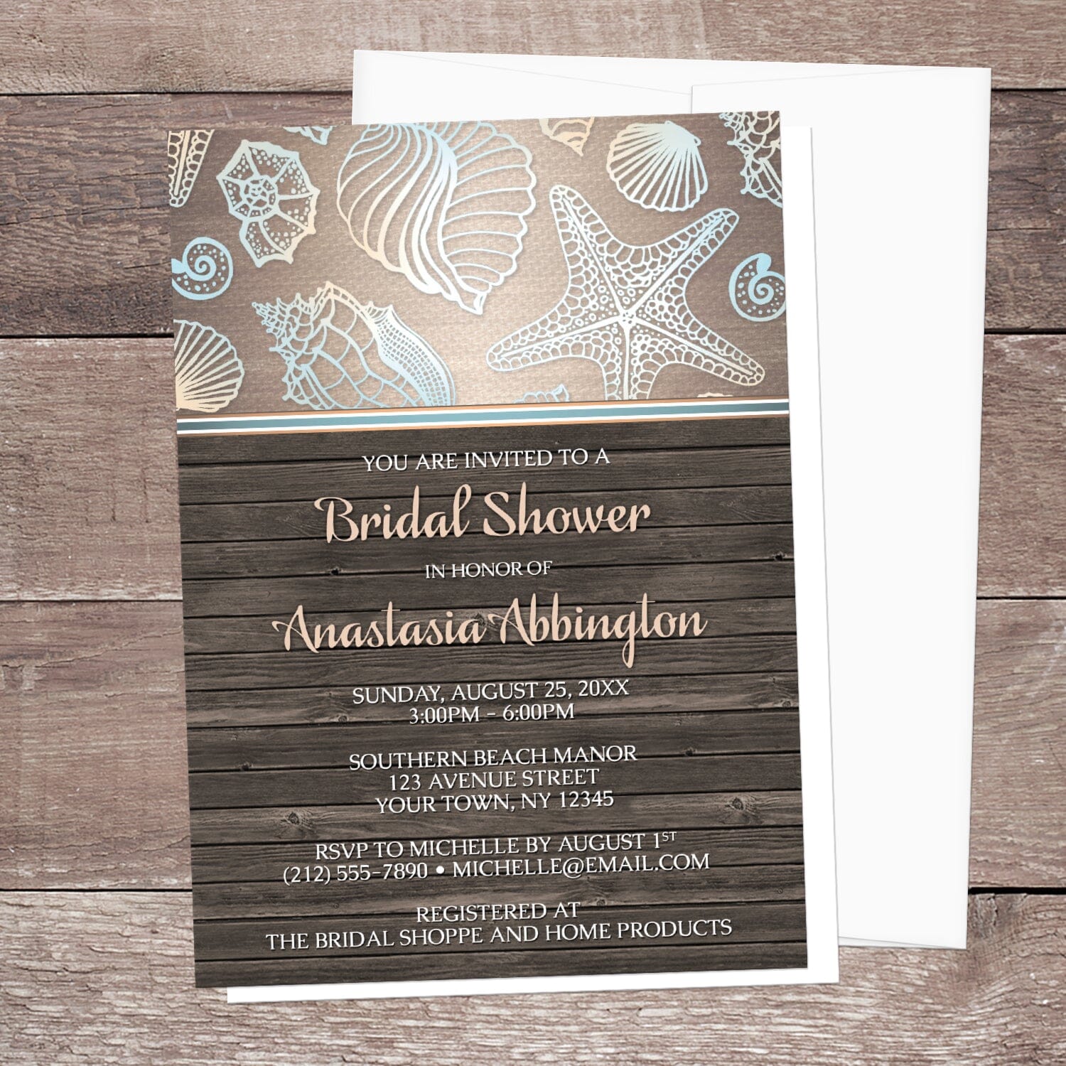 Rustic Wood Beach Seashell Bridal Shower Invitation shown on a wooden surface with a white envelope.