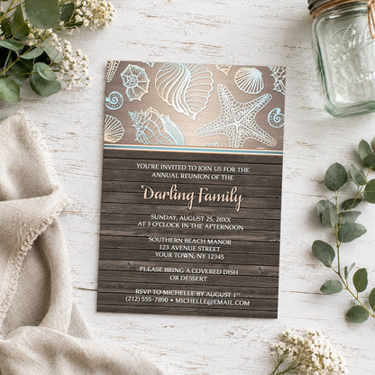 Rustic Wood Beach Seashell Family Reunion Invitation shown on a light wooden surface with neutral plants and a mason jar.