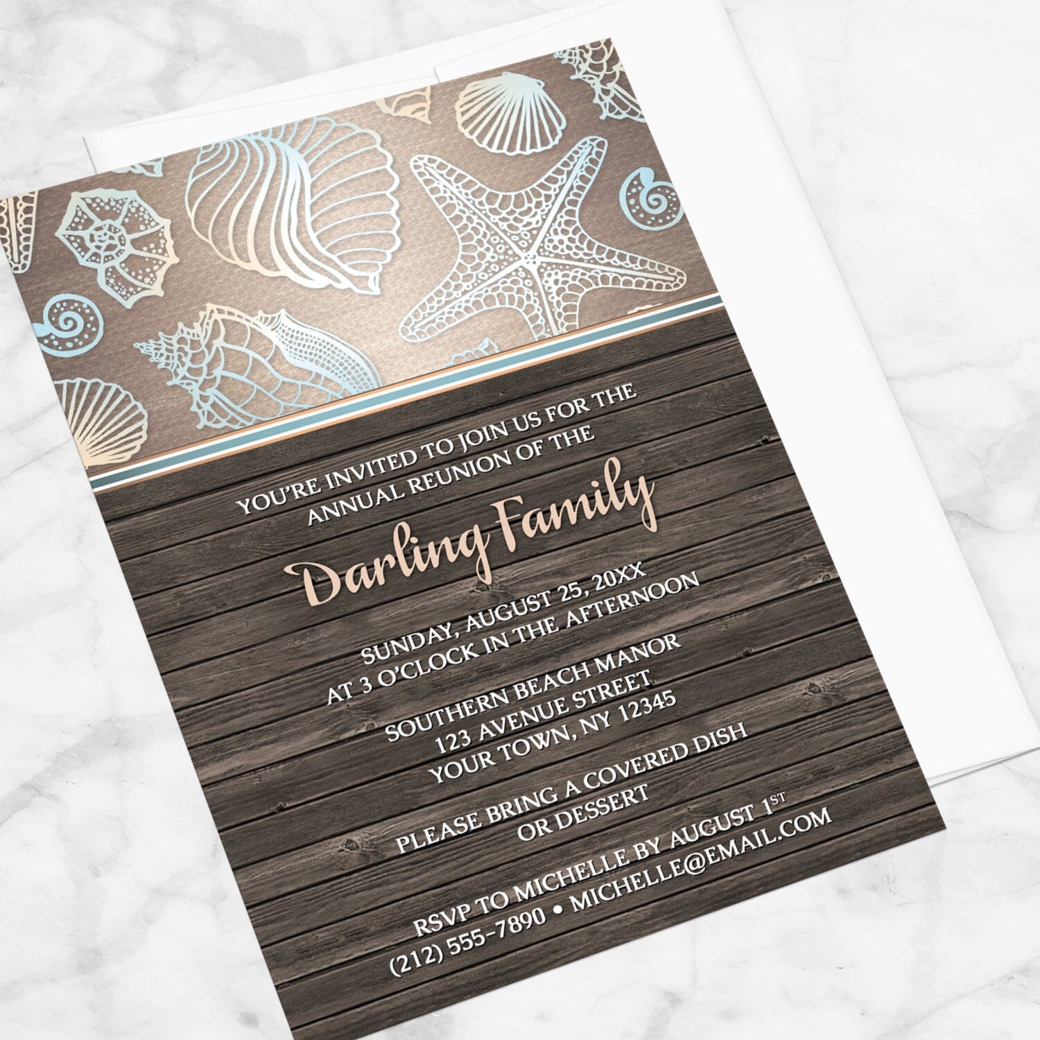 Rustic Wood Beach Seashell Family Reunion Invitation shown at an angle on a marble surface with a white envelope.
